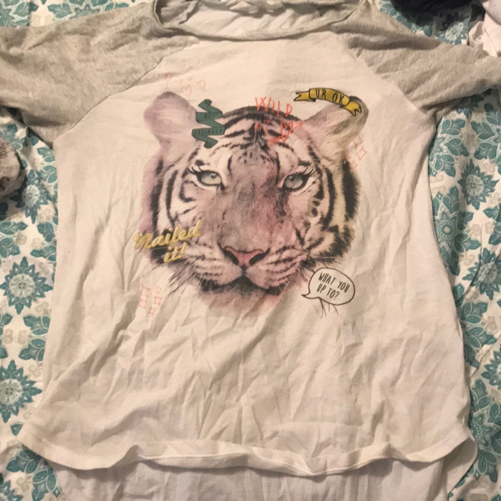 A gray and white shirt with the lion in the front